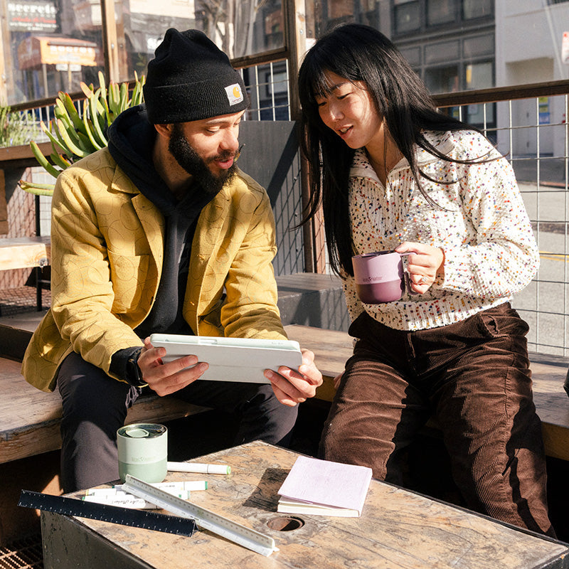12oz-rise-mug-w1 12oz_rise_coffee_mug_dusty_orchid_couple_city_patio_square.jpg