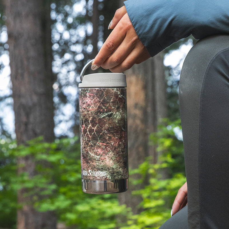 12oz-tkwide-with-twist-cap-mossy-oak-s9 12oz_tumbler_mossyoak_rainbowtrout_hand_closeup_square.jpg