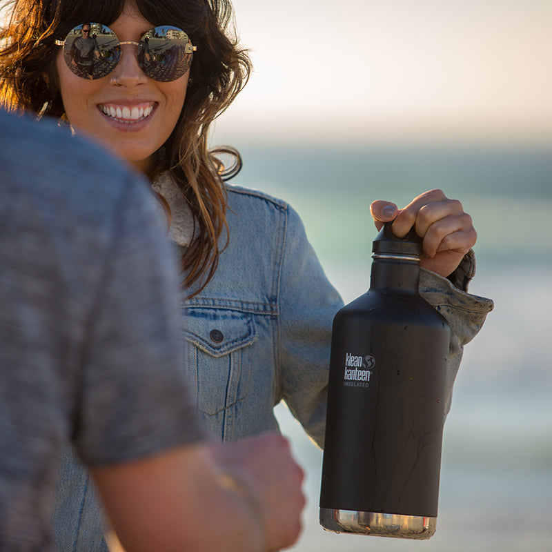 64oz-classic-with-loop-cap-q3 64oz_insulated_classic_black_beach_girl_hand_square.jpg
