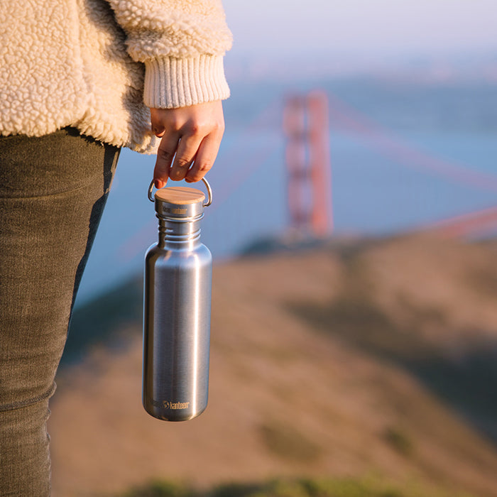 27oz-reflect-with-bamboo-cap-n1 K27SSLRF-BS-BAMBOO_reflect_bottle_bridge_lifestyle.jpg